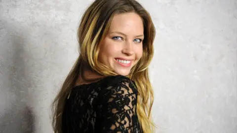 Actress Daveigh Chase smiles while looking over her shoulder at the 2011 premier of her HBO series Big Love.